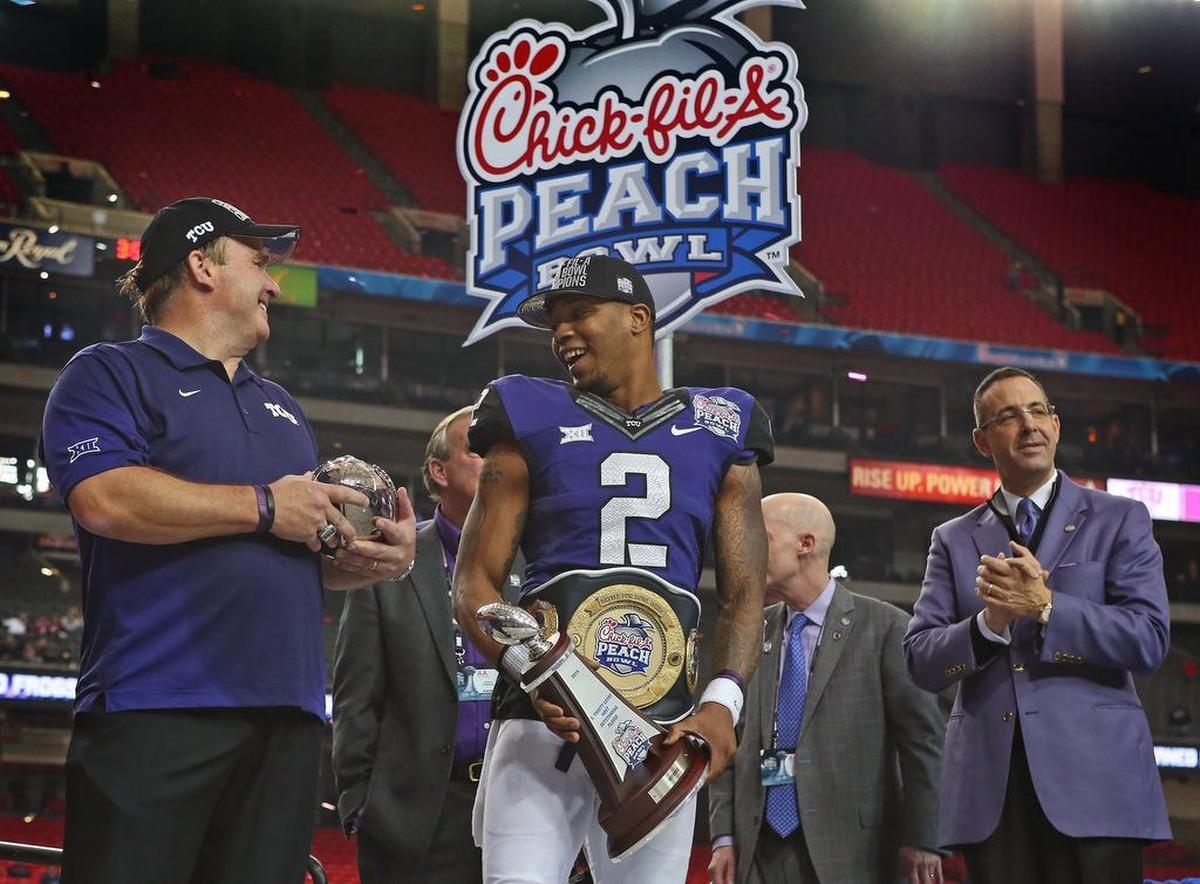 TCU coach Gary Patterson joins quarterback and game offensive MVP Trevone Boykin after the Horned Frogs beat Ole Miss 42-3 in the Peach Bowl. 