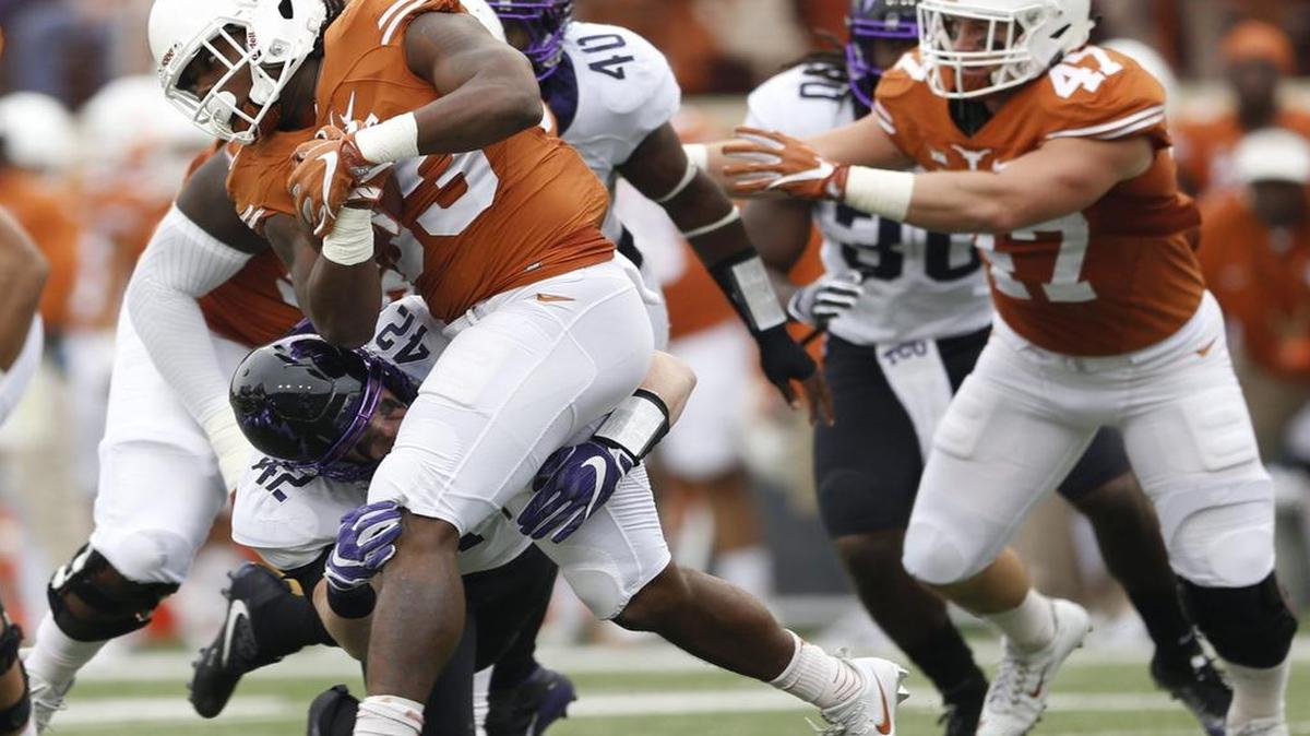 Texas running back D’Onta Foreman takes a hit from TCU linebacker Ty Summers during first-quarter action Friday at Royal-Memorial Stadium in Austin. Summers finished with 14 tackles and earned Big 12 defensive player of the week honors.