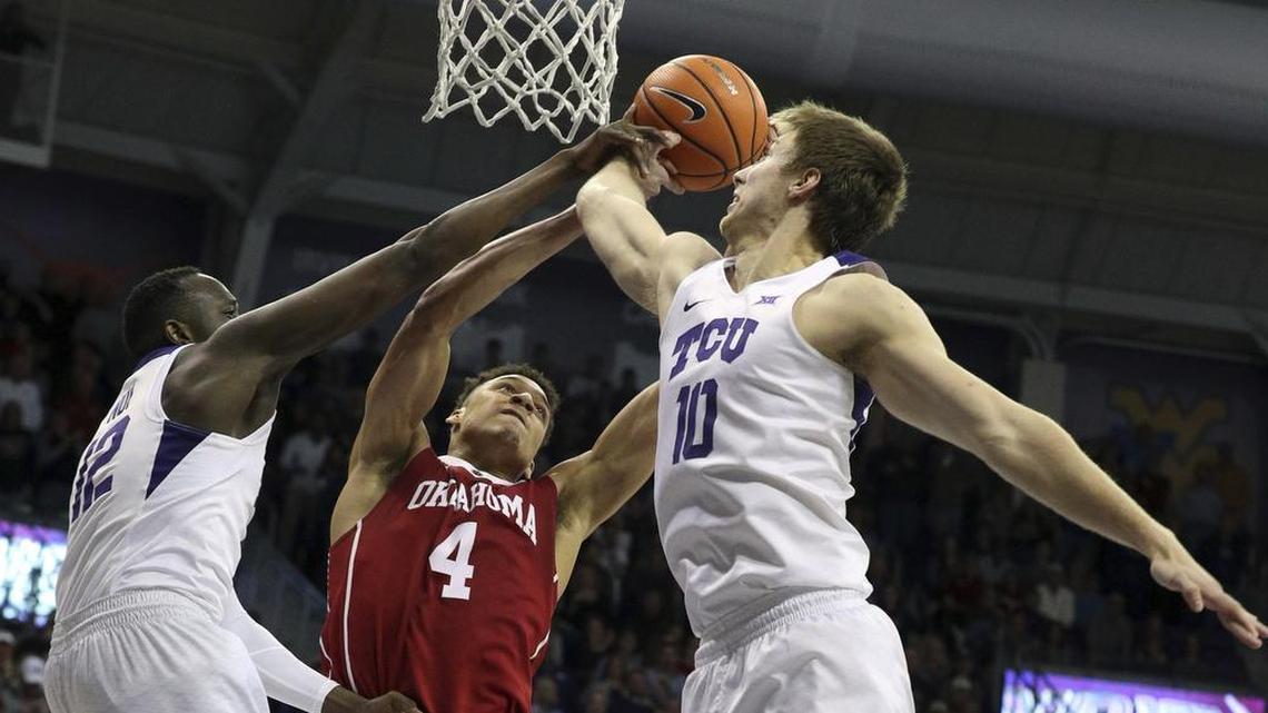 TCU forwards Kouat Noi (left) and Vladimir Brodziansky go up for a block attempt against the shot of Oklahoma center Jamuni McNeace during the Big 12 basketball opener for each team last week at Schollmaier Arena.