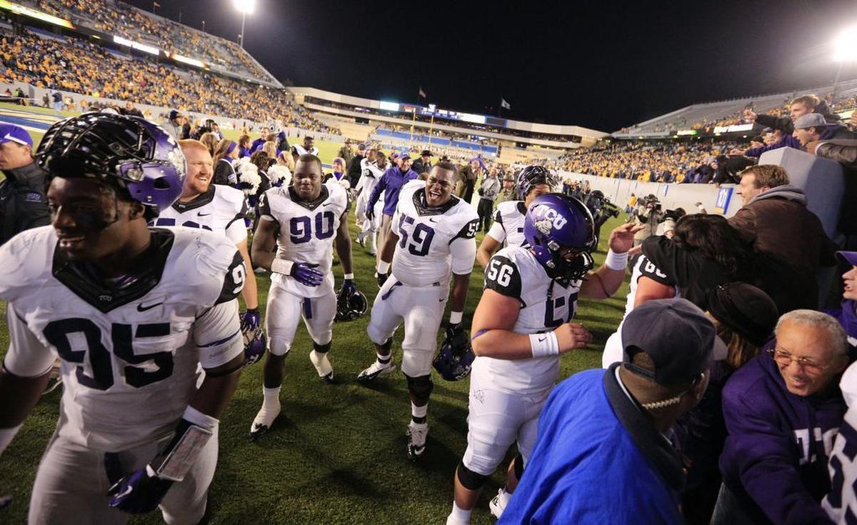 TCU players Devonte Fields, left, Stansly Maponga, Tayo Fabuluje and Joey Hunt celebrate the Horned Frogs’ 39-38 overtime win against No. 23 West Virginia in Morgantown, W.Va. on Nov. 3, 2012.