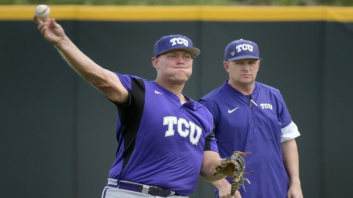 TCU baseball coach Jim Schlossnagle, right, keeps an eye on first baseman Luken Baker during a practice at Lupton Stadium on Tuesday. Baker is rated the 12th top college prospect for the MLB draft in June.