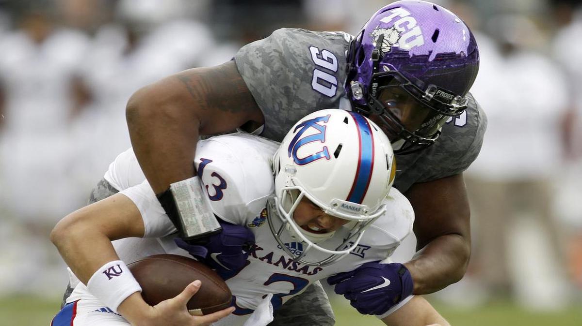 TCU defensive end Terrell Lathan sacks Kansas quarterback Ryan Willis to secure the Horned Frogs’ 23-17 win Saturday.