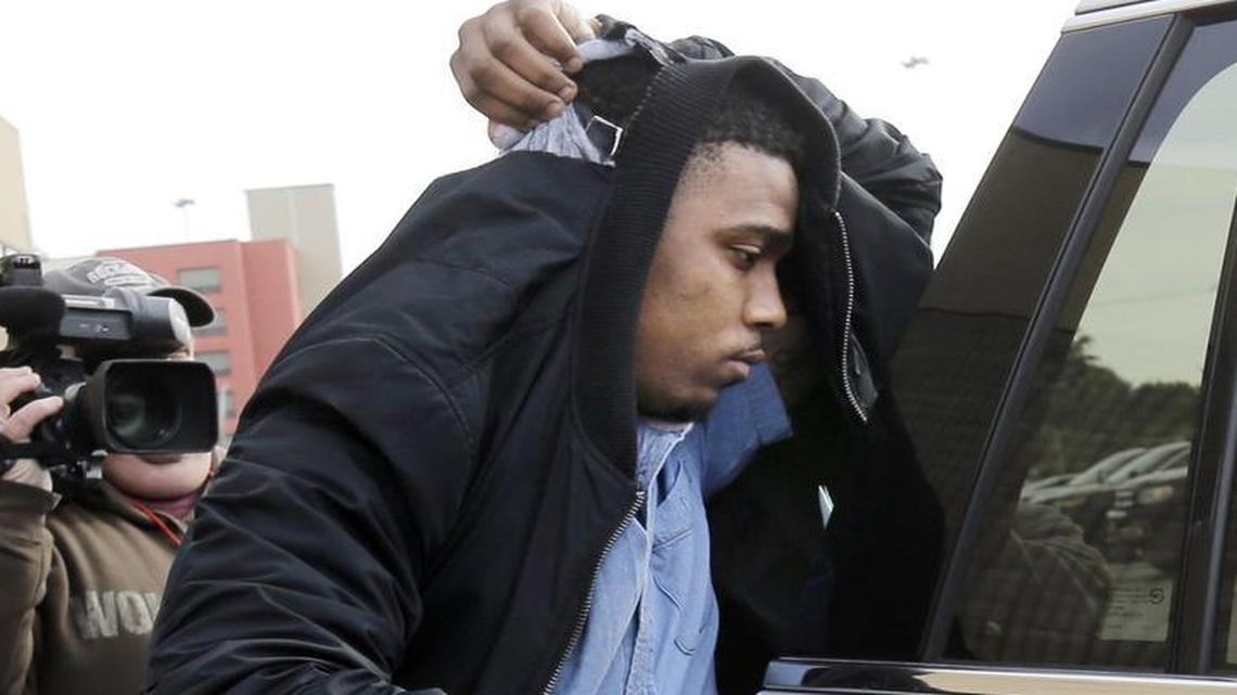 TCU quarterback Trevone Boykin is escorted from a detention center after he was released on bail Thursday in San Antonio.
