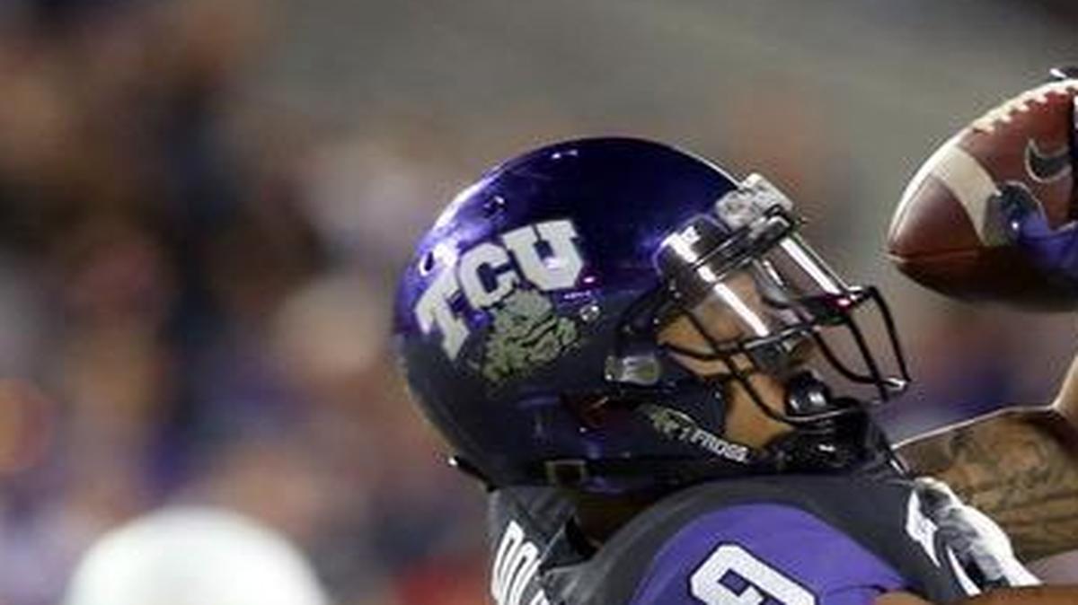 TCU receiver Josh Doctson comes down with a catch as West Virginia safety K.J. Dillon closes in during an Oct. 29 game in Fort Worth. Doctson, who has set five school records, has been named a Biletnikoff Award finalist.