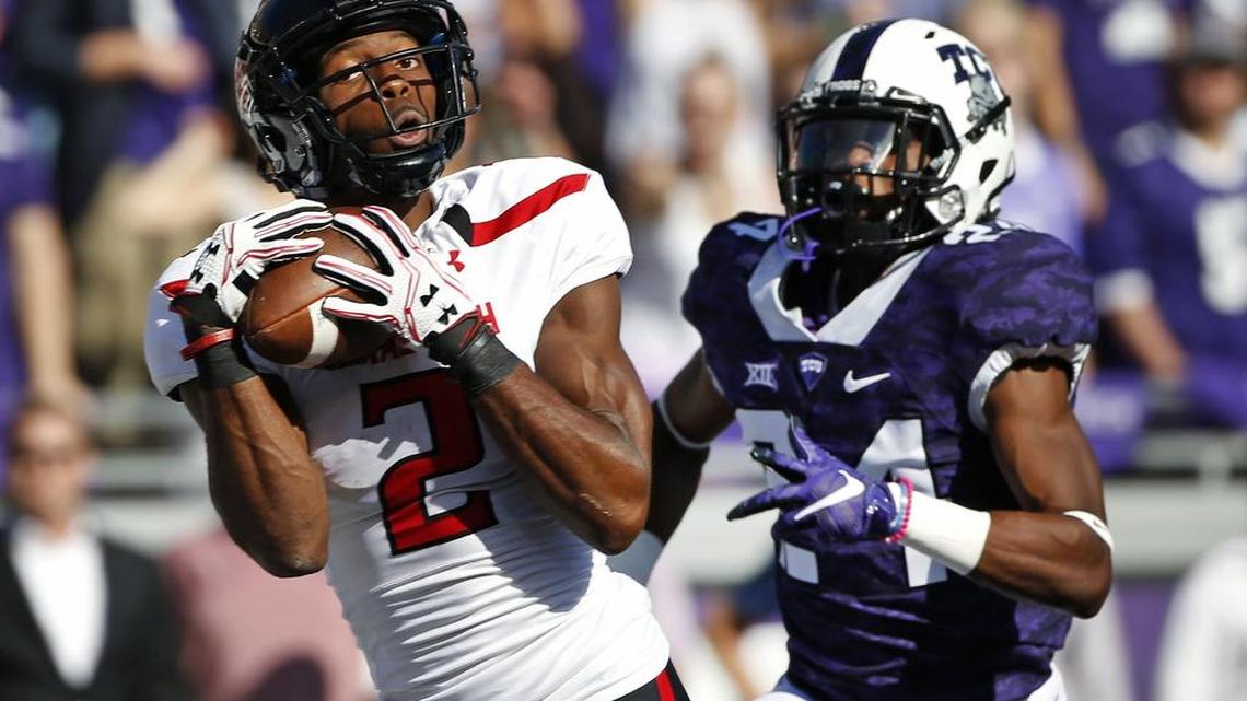 Texas Tech wide receiver Reginald Davis III catches a touchdown pass in front of TCU cornerback Julius Lewis.