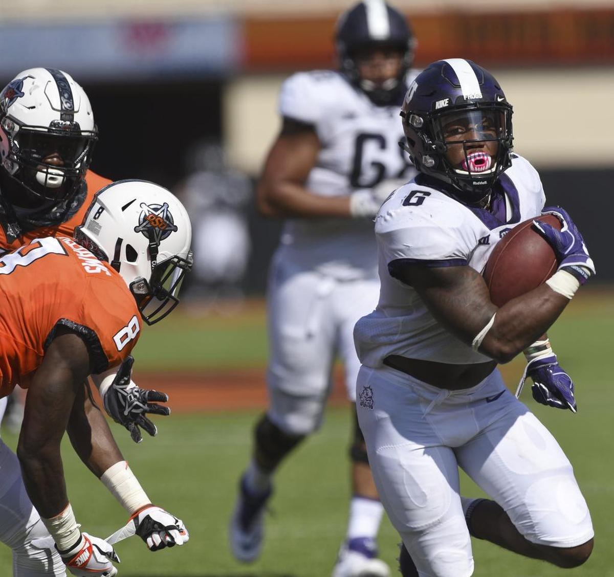 TCU running back Darius Anderson, right, breaks away from Oklahoma State defensive end Tralund Webber, left, and safety Za'Carrius Green to score a touchdown in the first half of the Horned Frogs’ win on Sept. 23, 2017 in Stillwater, Okla.