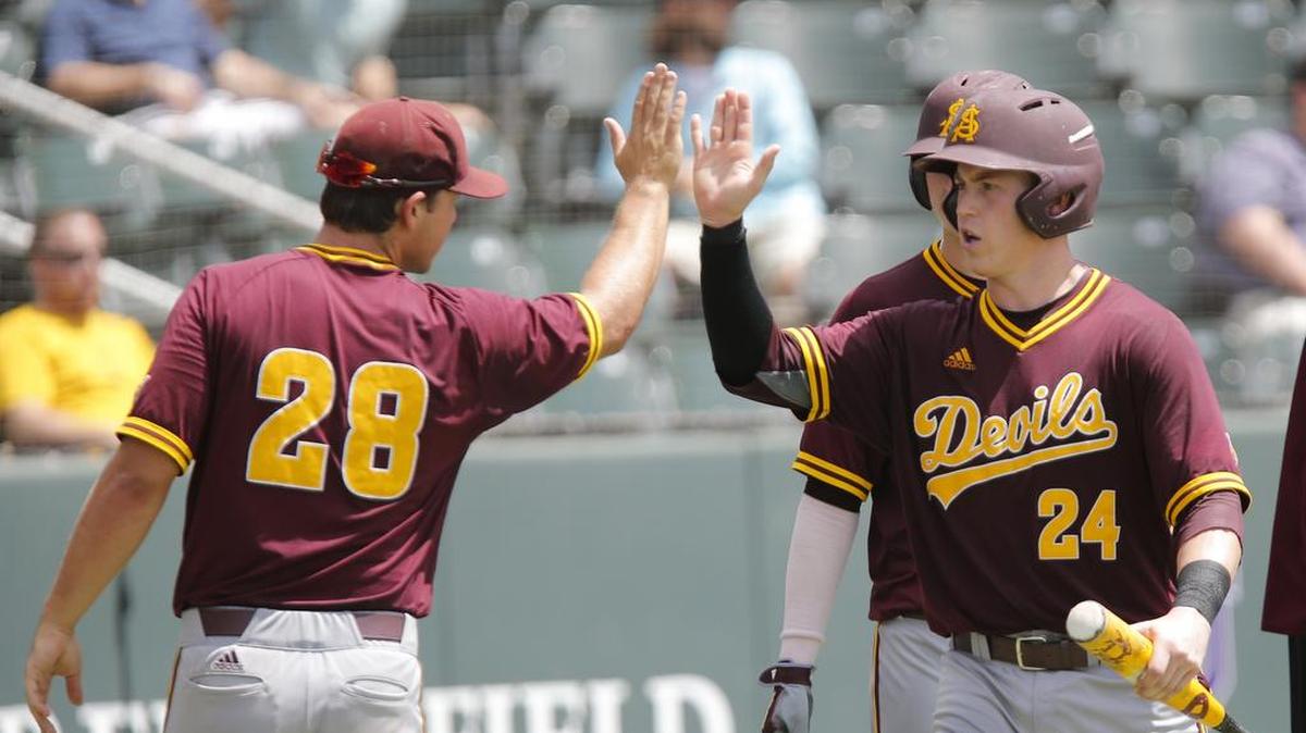 Arizona State catcher Brian Serven (right) is greeted by David Greer after scoring in the fourth inning on Andrew Snow’s single for a 2-0 lead against Oral Roberts at the Fort Worth Regional.