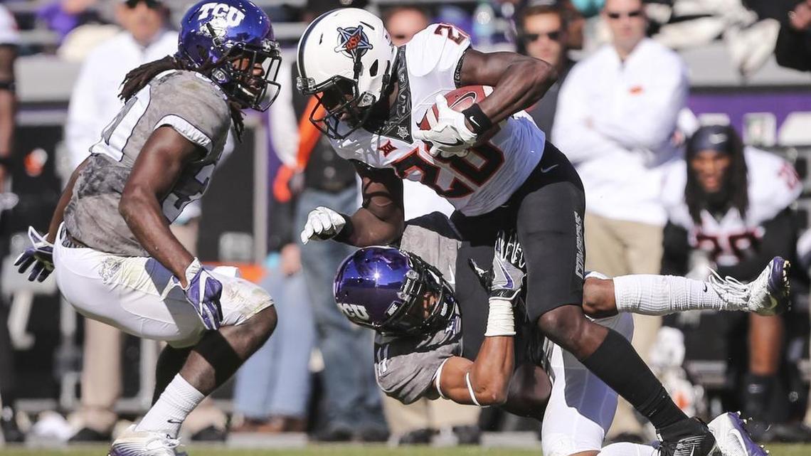 TCU’s Ranthony Texada, bringing down Oklahoma State’s James Washington during last season’s game in Fort Worth, said the Horned Frogs are more focused on the road.