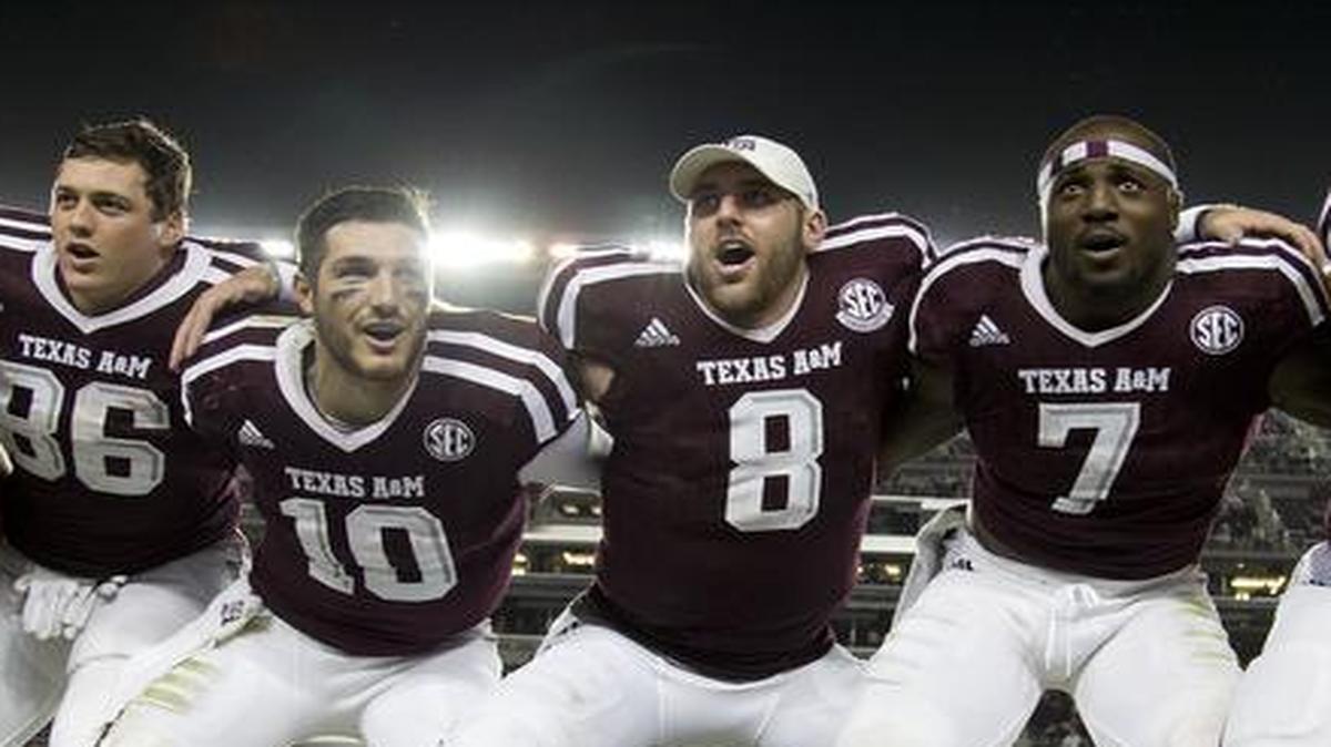 Texas A&M’s Trevor Knight (8) sways along with teammates during the singing of the Aggie War Hymn after the team’s 52-10 win over New Mexico State on Saturday in a nonconference game. A finish that would give A&M an 11-1 record may make the Aggies a contender for one of the four College Football Playoff berths.