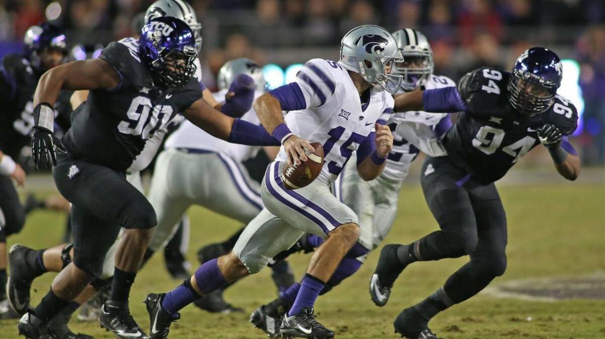 TCU defenders Terrell Lathan (left) and Josh Carraway pursue Kansas State quarterback Jake Waters during third-quarter action of a 2014 game at Amon G. Carter Stadium. This year’s game between the teams will kick off at 11 a.m. on Dec. 3, the Big 12 announced.