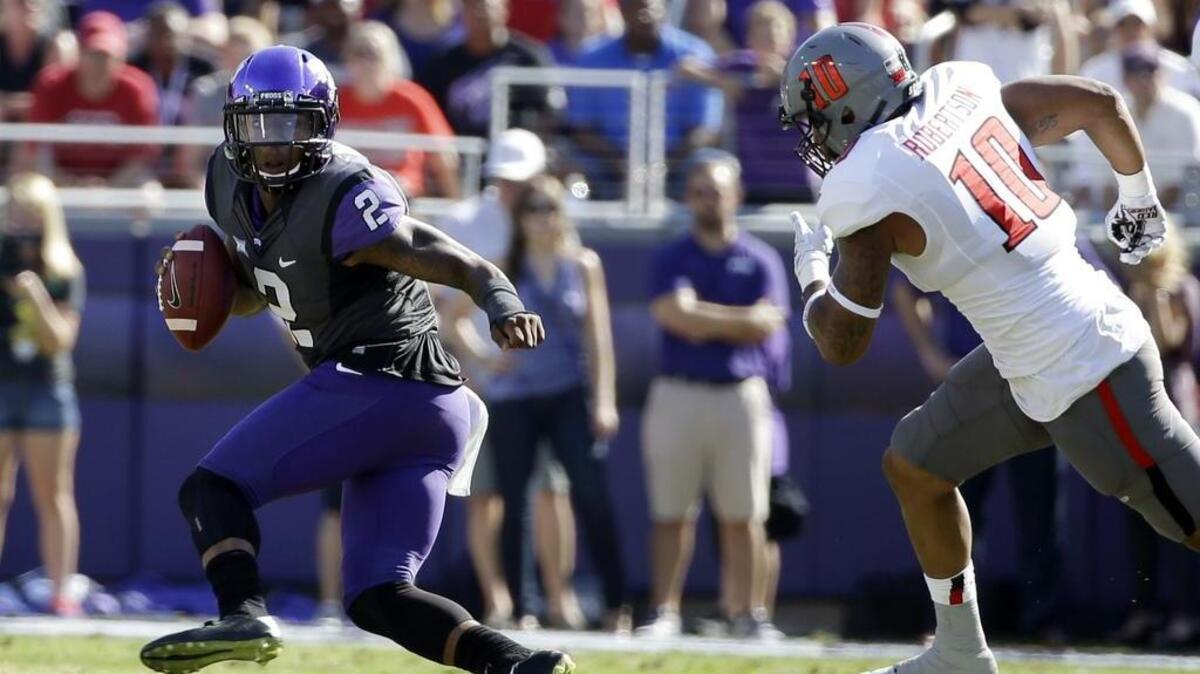 TCU quarterback Trevone Boykin makes a move to evade Texas Tech linebacker Pete Robertson in this file photo from an Oct. 25, 2014, game at Amon G. Carter Stadium. TCU won 82-27. This year’s game on Oct. 22 in Fort Worth kicks off at 2:30 p.m., the Big 12 announced Monday.