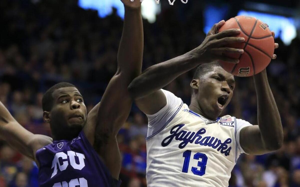 Kansas forward Cheick Diallo secures a rebound against TCU’s Chris Washburn during second-half action Saturday in Lawrence. Diallo had nine points and nine rebounds for Kansas in its 70-63 victory.
