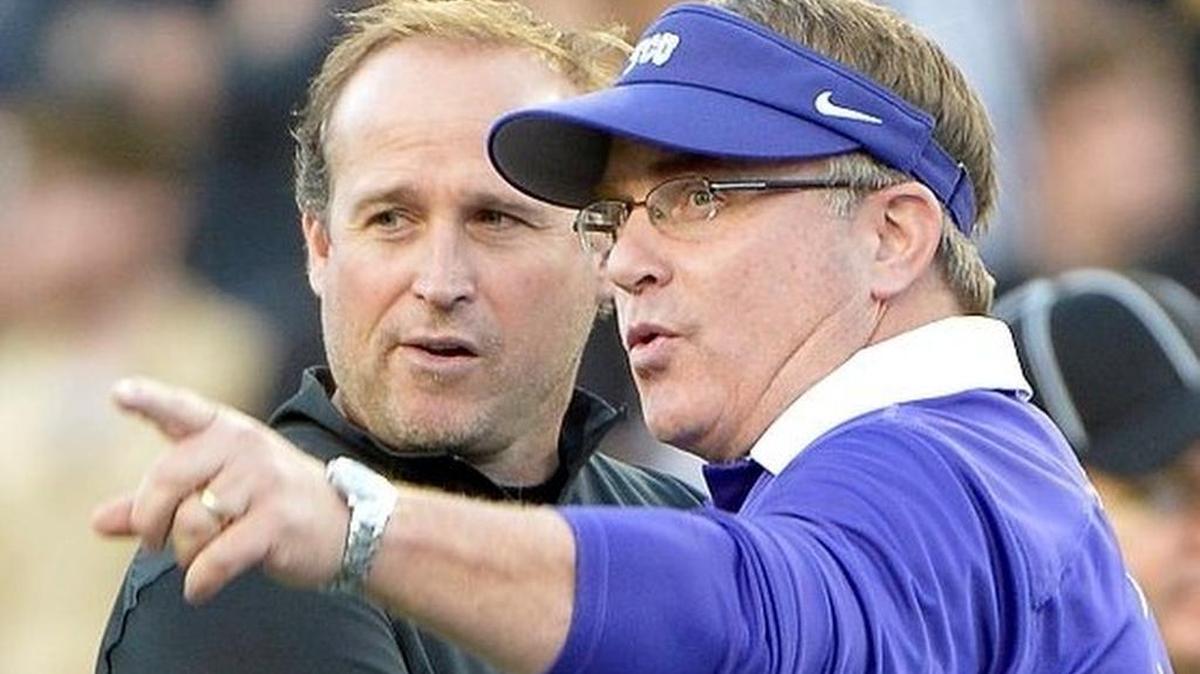 TCU coach Gary Patterson visits with West Virginia coach Dana Holgorsen before the game.