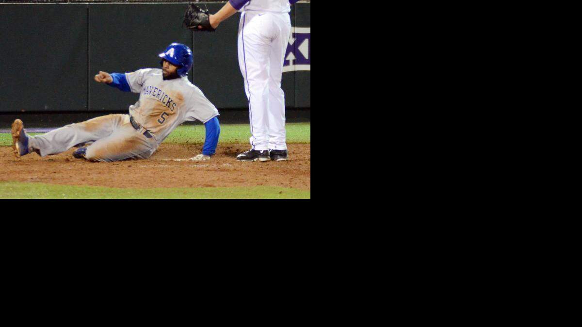 
UTA’s Darien McLemore, left slides across home plate to score on an errant pitch by TCU’s Riley Ferrell in the ninth inning for the Mavericks’ only run Tuesday night.
