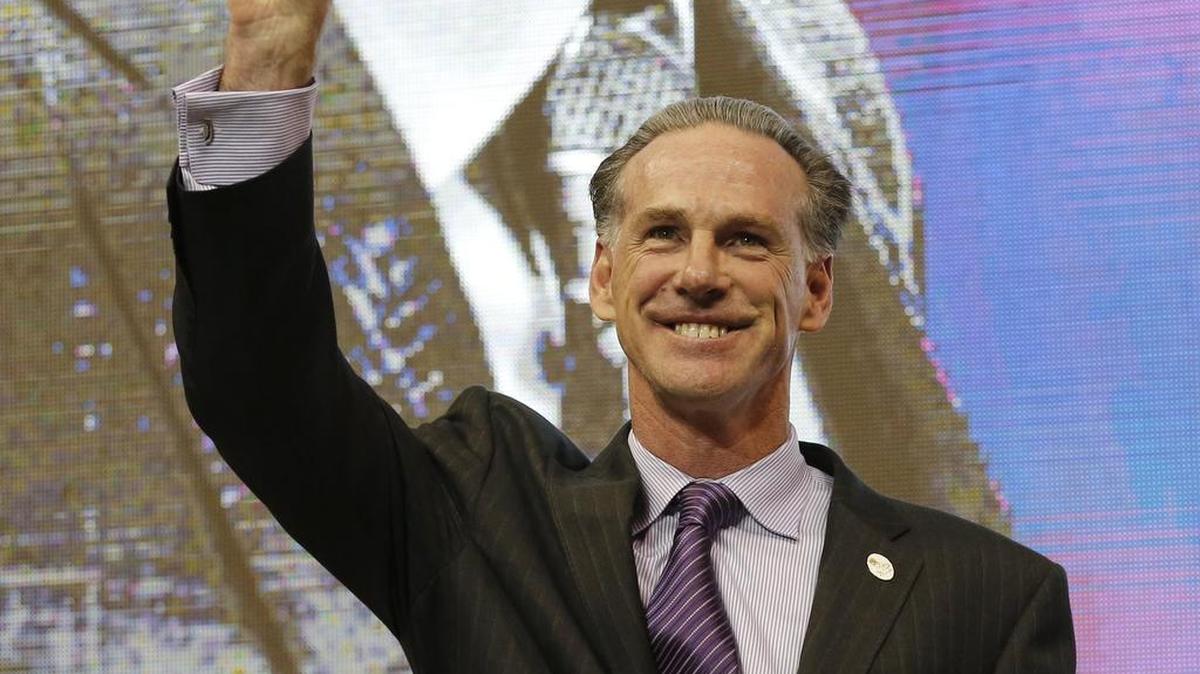 Jamie Dixon gives the Frogs hand sign after being announced as the new TCU men’s basketball coach Tuesday.