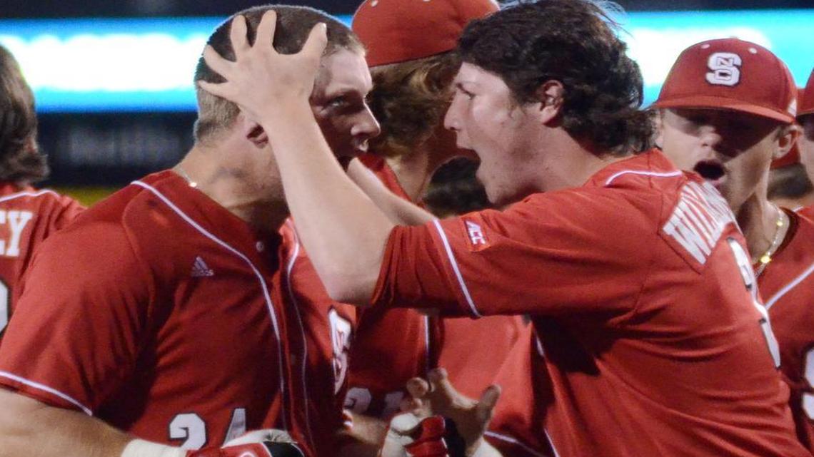 
North Carolina State's Chance Shepard, left, celebrates with teammate Ryan Williamson after hitting a 2 run home run to take a 5-4 lead over TCU in the ninth inning of Saturday's May 30, 2015 Regional baseball game at Lupton Stadium in Fort Worth. 
