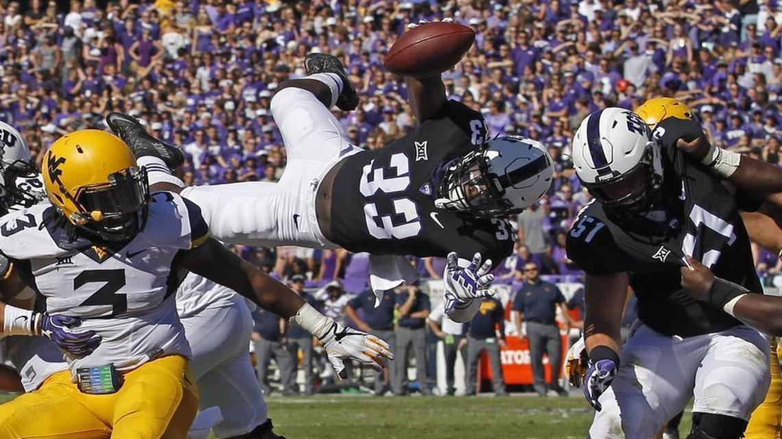 TCU running back Sewo Olonilua dives for the end zone to complete a 1-yard touchdown run in the second quarter.