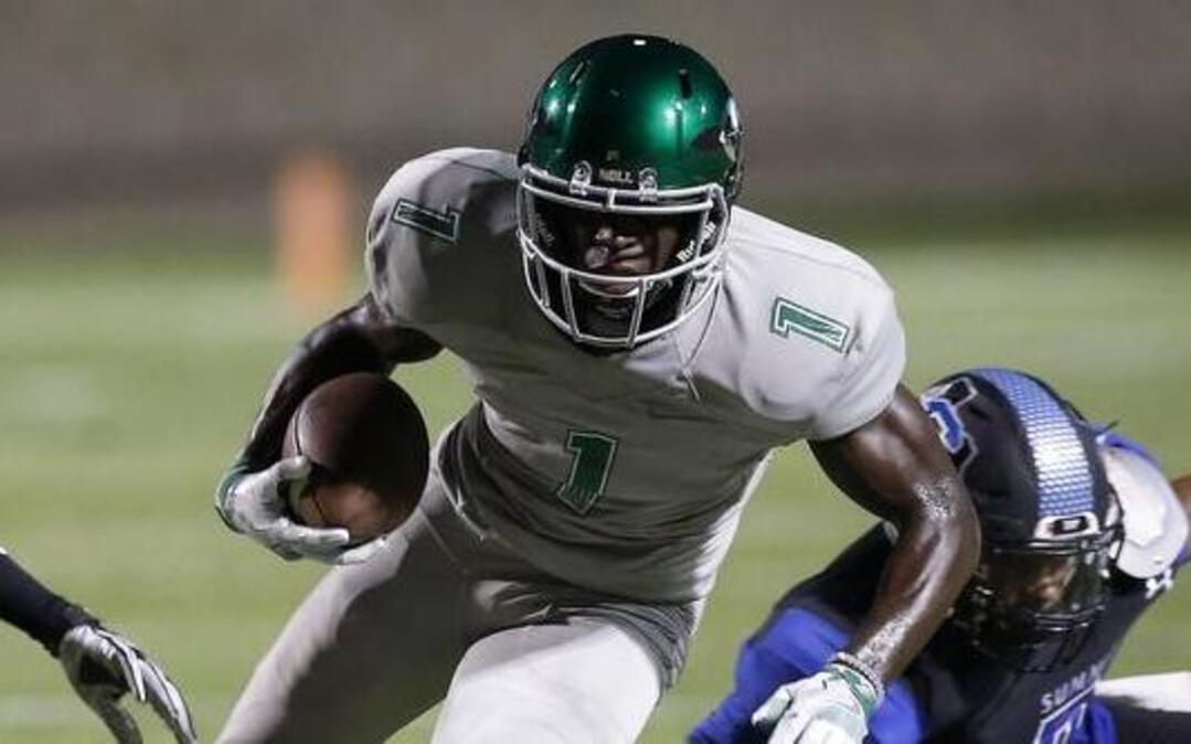 Waxahachie High School receiver Jalen Reagor (1) splits through Mansfield Summit Jaguars linebacker Charles Ayena (34) and cornerback Rommell Jackson (7) in the first half at Newsom Stadium in Mansfield, Texas on Friday, Sept. 16, 2016.