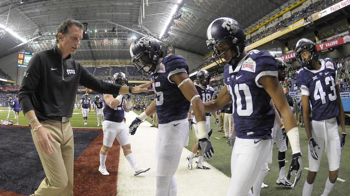 Doug Meacham, going through pregame drills with TCU at the Alamo Bowl in January 2016, now leads the Kansas offense into Saturday night’s matchup at Amon G. Carter Stadium.