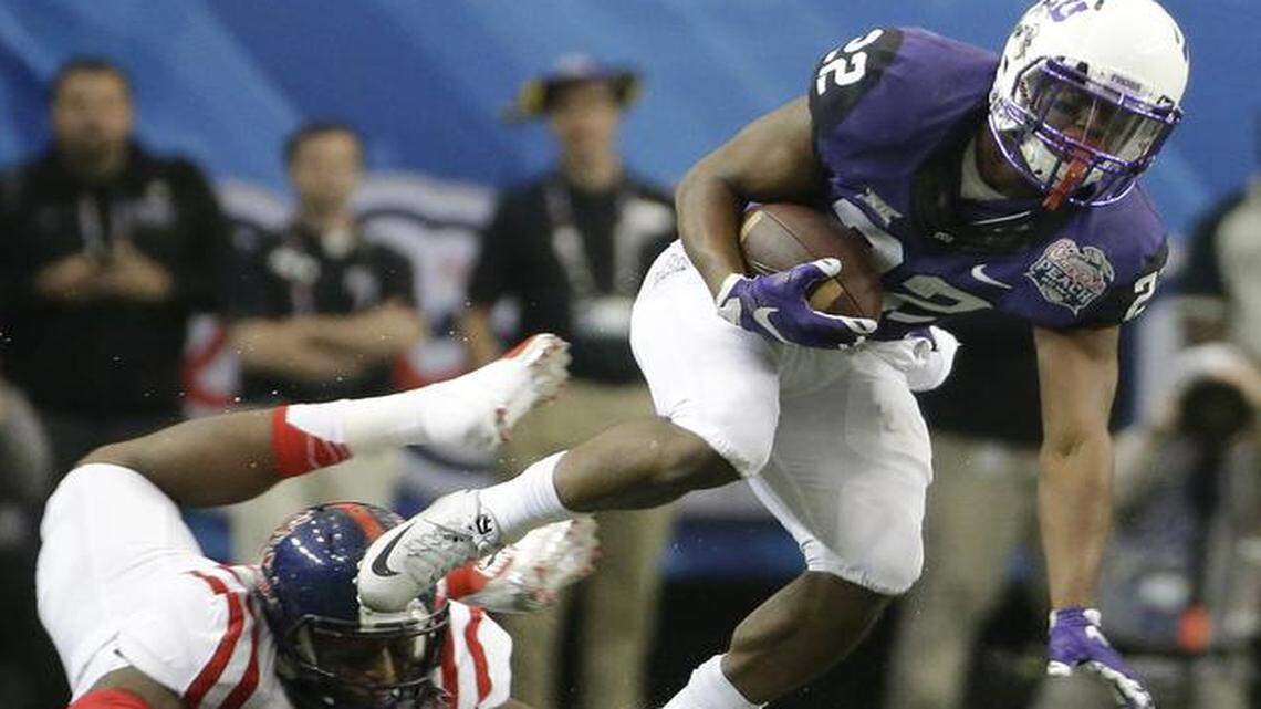 
TCU running back Aaron Green (22) runs by Mississippi defensive back Kendarius Webster (15) during the first half of the Peach Bowl. (AP Photo/David Goldman)
