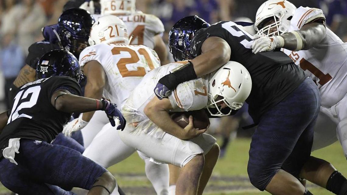 TCU defensive tackle Ross Blacklock brings down Texas quarterback Shane Buechele for one of seven sacks by the Horned Frogs defense in a Big 12 game Nov. 4 at Amon G. Carter Stadium.