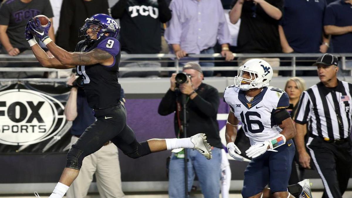 TCU receiver Josh Doctson, left, hauls in a 17-yard touchdown catch in the first quarter against West Virginia cornerback Terrell Chestnut. Doctson added a 9-yard TD catch in the third quarter.