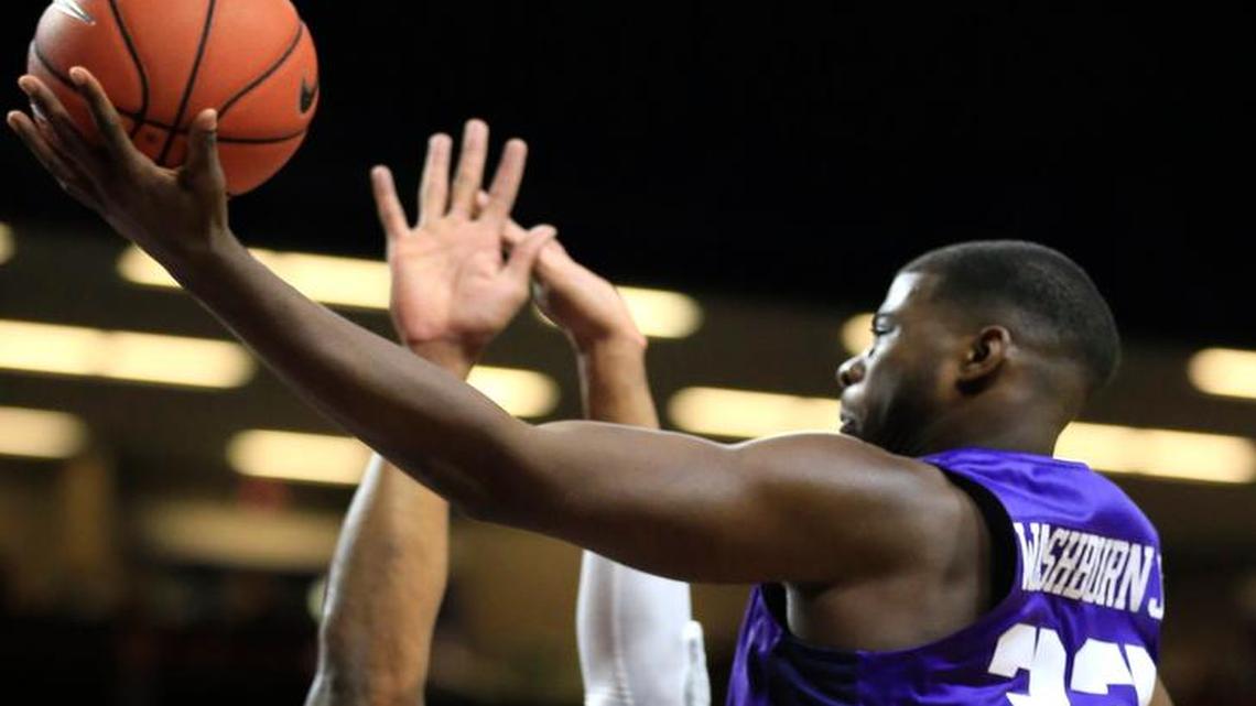 TCU forward Chris Washburn (33) drives on Kansas State forward Stephen Hurt (41) during the first half.