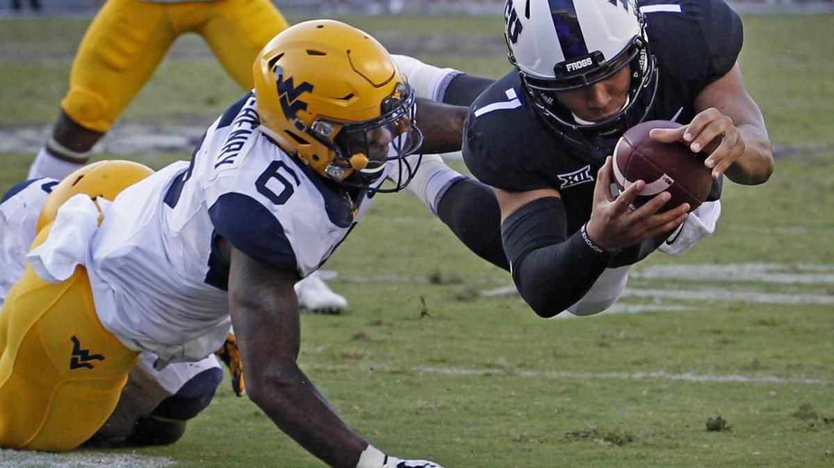 TCU Horned Frogs quarterback Kenny Hill (7) dives into the end zone for a fourth-quarter touchdown from 3 yards out as TCU beats West Virginia 31-24 in Fort Worth, Saturday, October 7, 2017