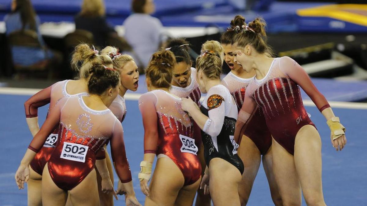 The Oklahoma team gathers before their floor exercises at the NCAA Women’s National Collegiate Gymnastics Championships at the Fort Worth Convention Center on Friday. The Sooners posted the highest score of the semifinals.