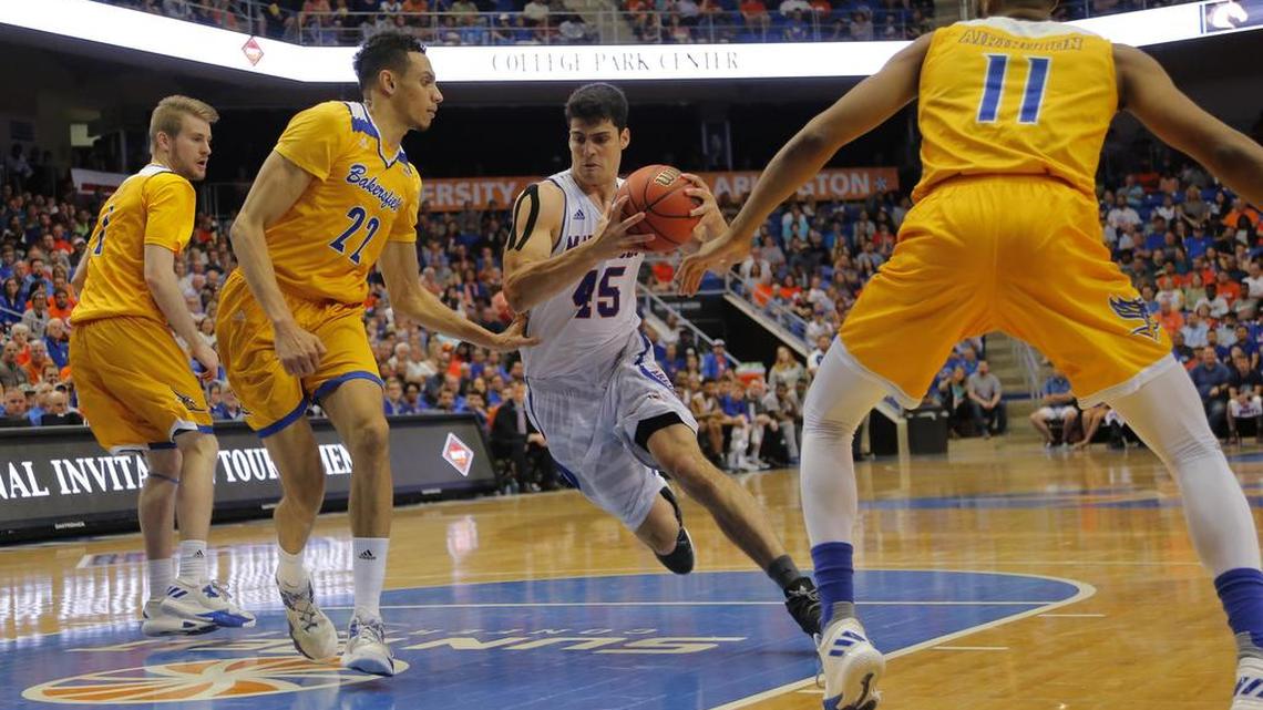 Texas-Arlington’s Jorge Bilbao (45) drives to the basket against Cal State Bakersfield’s Moataz Aly (22) and Jaylin Airington (11) in a National Invitation Tournament quarterfinal at College Park Center.