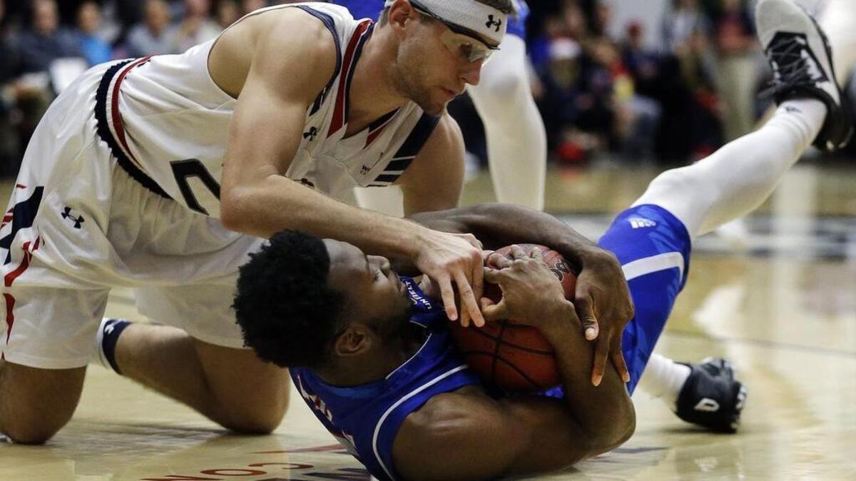 UT Arlington’s Kaelon Wilson, right, battles for the ball with St. Mary’s Calvin Hermanson. Diving for loose balls is a part of the Mavericks’ culture.