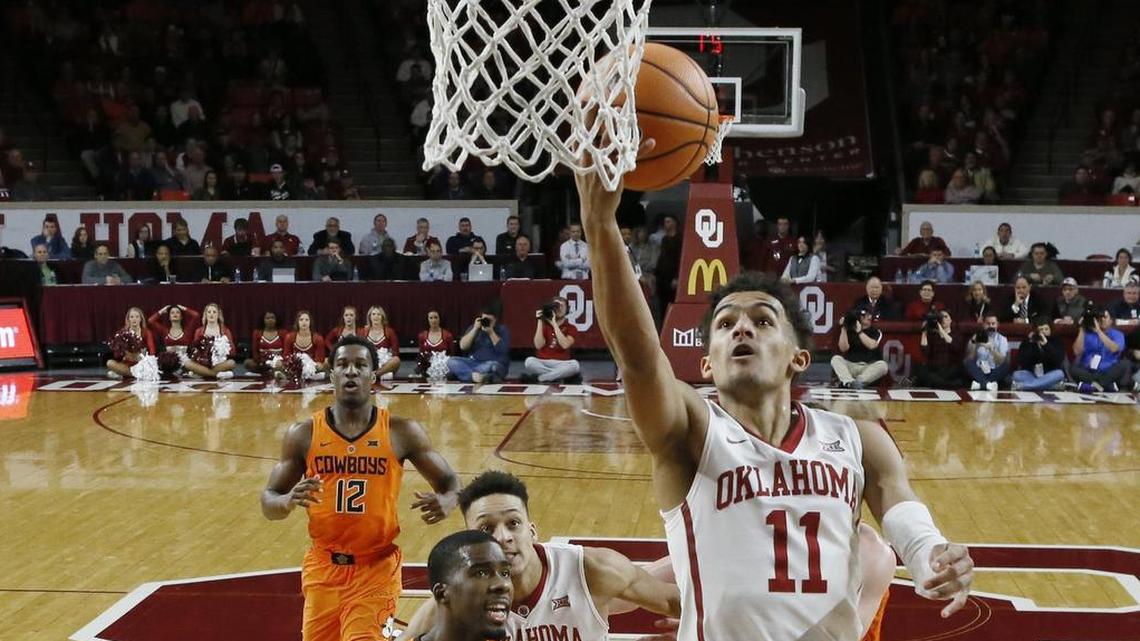 Oklahoma guard Trae Young (11) shoots in front of Oklahoma State guard Tavarius Shine (5) during the first half Wednesday in Norman, Okla.