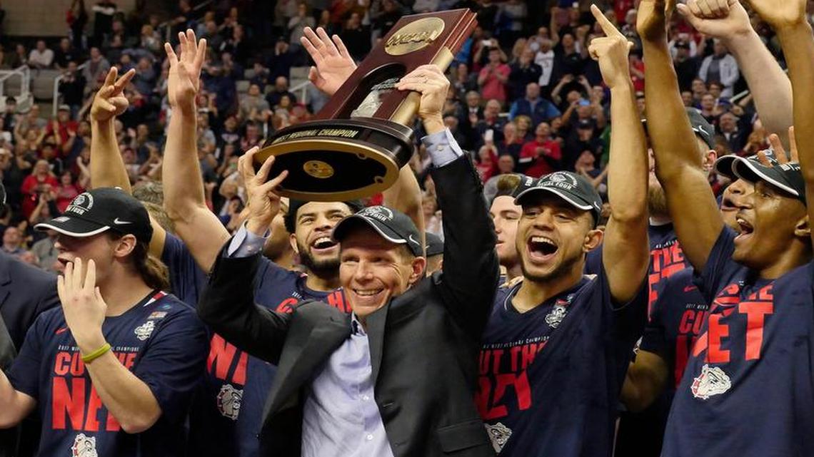 Gonzaga head coach Mark Few holds up the NCAA West Region trophy after an 83-59 win against Xavier at SAP Center in San Jose, Calif., on Saturday, March 25, 2017.