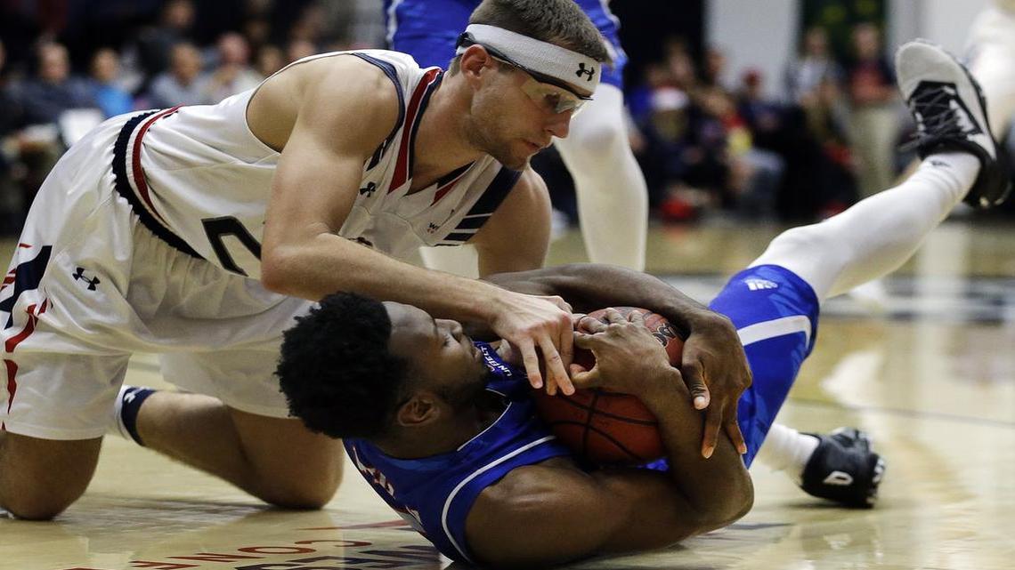Saint Mary’s Calvin Hermanson, top, and UT Arlington’s Kaelon Wilson fight for the ball during the first half of an NCAA college basketball game Thursday, Dec. 8, 2016, in Moraga, Calif.