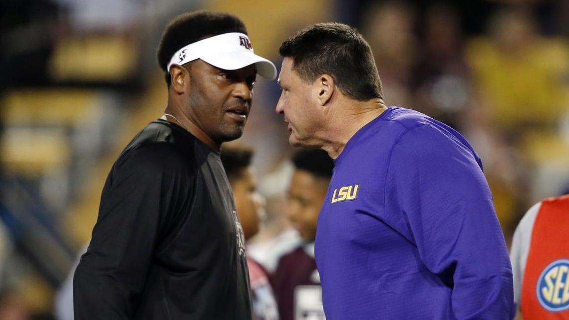 Texas A&M head coach Kevin Sumlin, left, greets LSU head coach Ed Orgeron before their regular-season finale Saturday night in Baton Rouge, La.