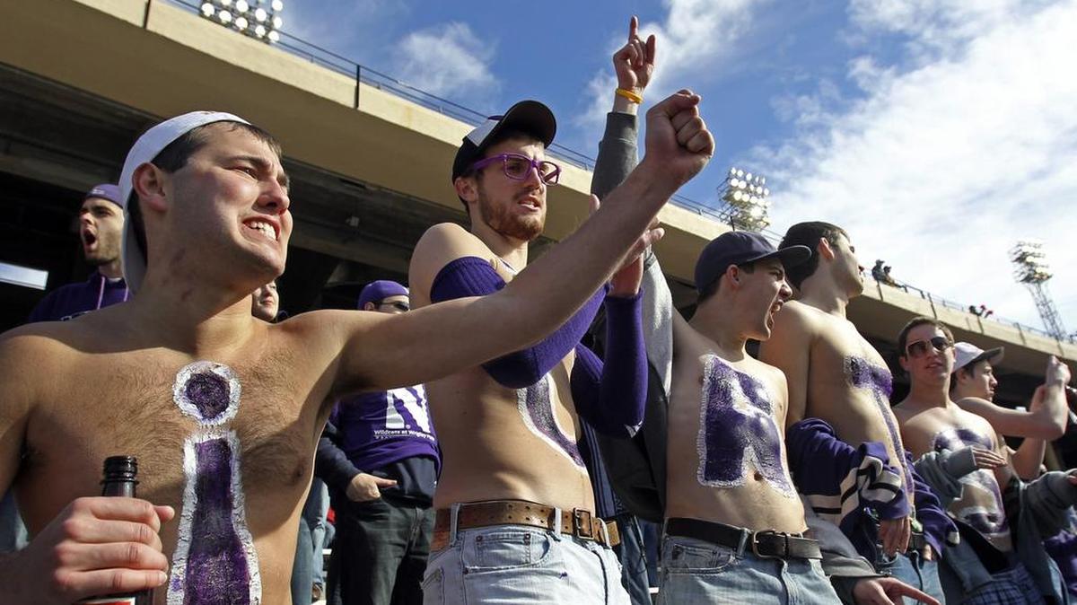 Northwestern fans enjoy the weather and festive atmosphere as they cheer on the Wildcasts against Texas Tech in the TicketCity Bowl at the Cotton Bowl in Dallas on Jan. 1, 2011.