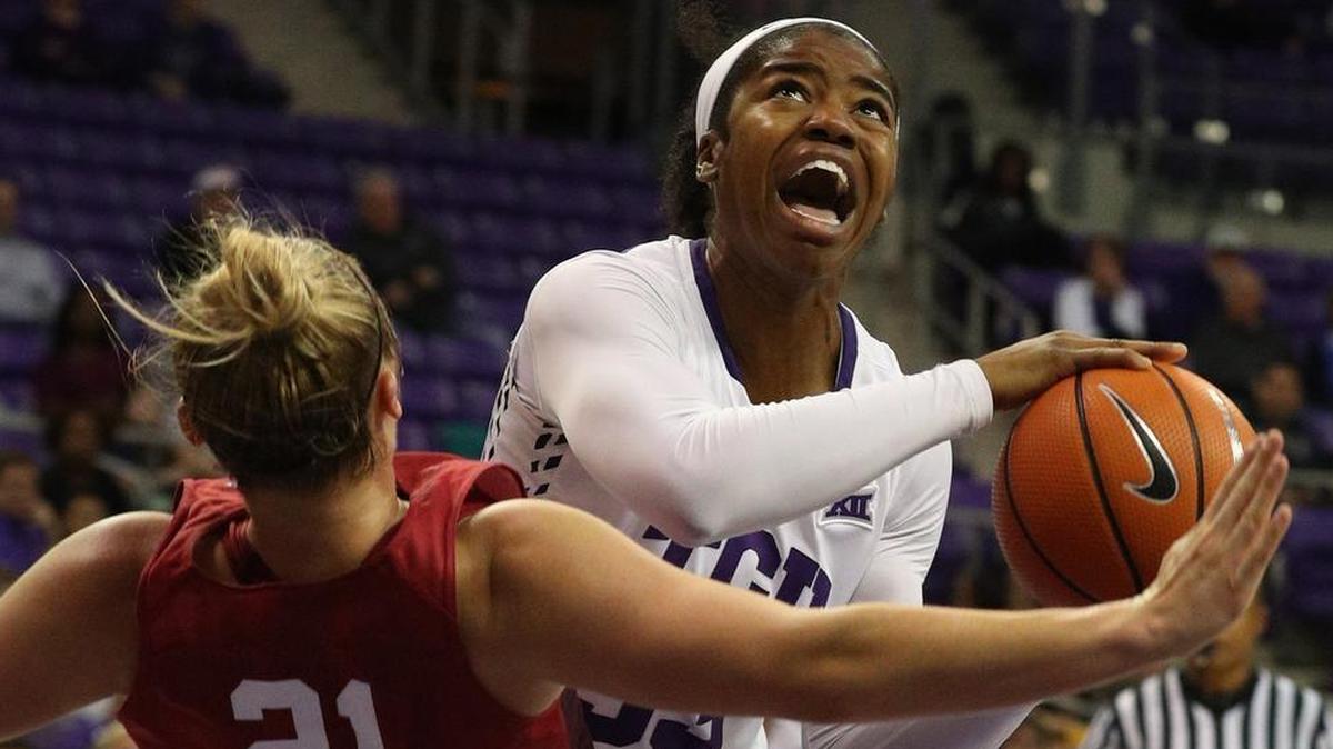 TCU forward Adeola Akomolafe drives through an Oklahoma defender for a shot in a recent game.