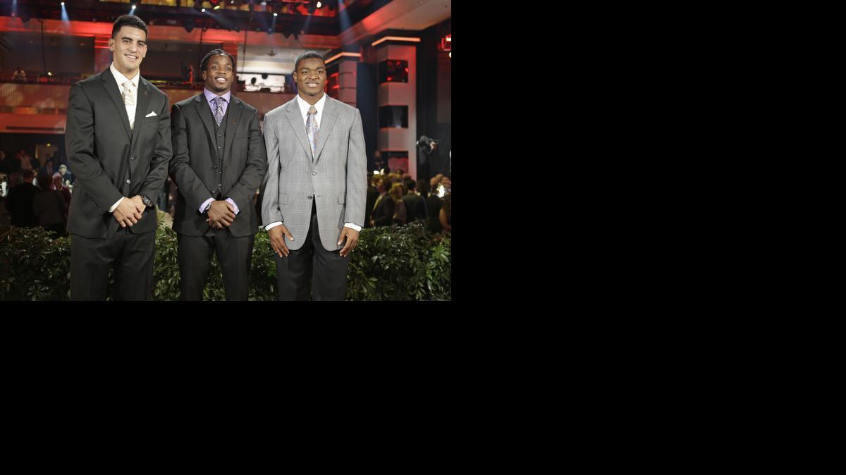 
Heisman Trophy candidates, from left, Oregon's Marcus Mariota, Wisconsin's Melvin Gordon and Alabama's Amari Cooper pose for a photo at the College Football Awards, Thursday. The winner of the Heisman Trophy will be announced on Saturday. 
