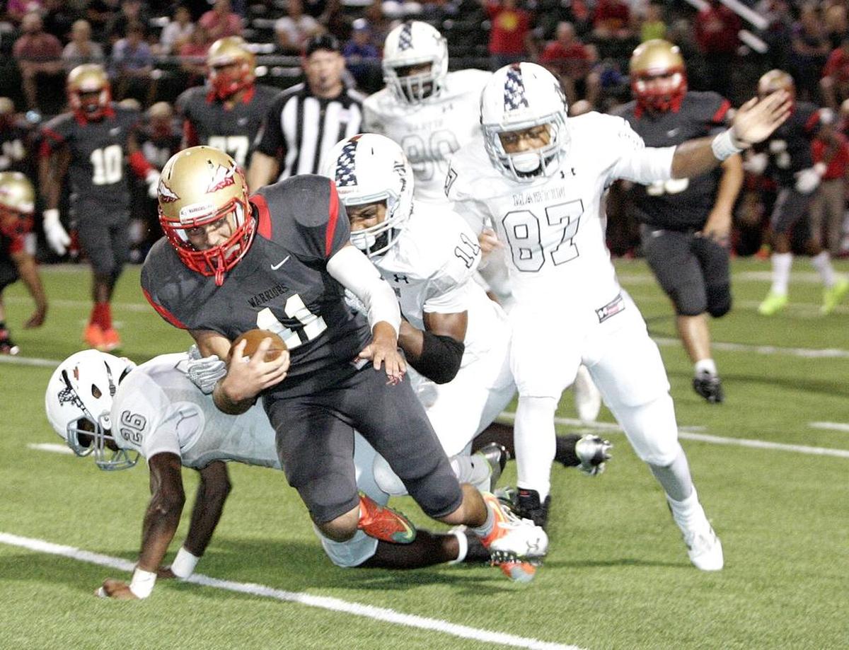 South Grand Prairie’s Greg Eisworth is brought down by Martin’s defense. 