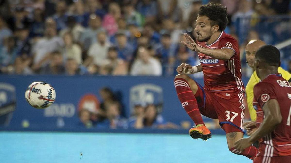 FC Dallas forward Maximiliano Urruti jumps over the Montreal Impact’s Victor Cabrera during second-half MLS soccer game action in Montreal, Saturday, July 22, 2017. FC Dallas faces Vancouver at 7 p.m. Saturday at Toyota Stadium in Frisco, and the telecast is on KTXA/Channel 21.