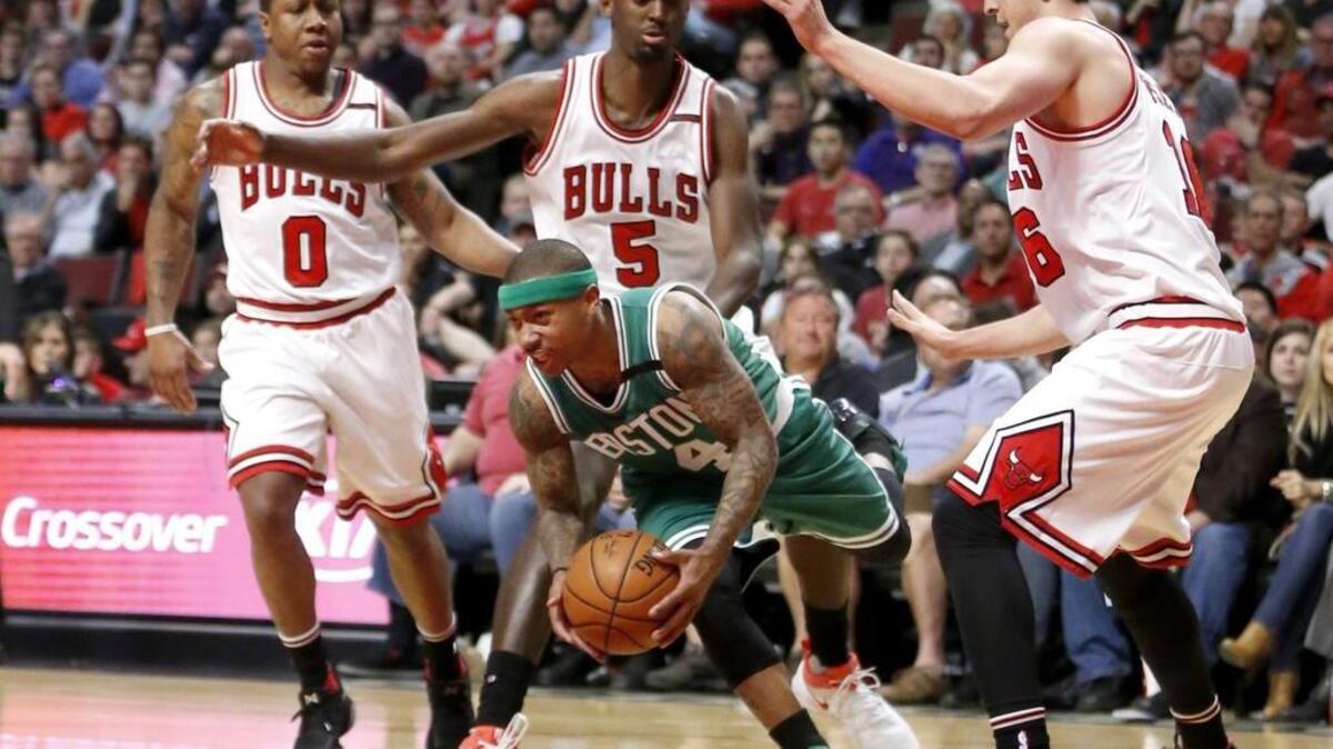 Point guard Isaiah Thomas, center, and the Boston Celtics try to break free of the Chicago Bulls in Game 5 Wednesday with their first-round series tied at 2 games apiece. The game will be televised at 7:30 p.m. on TNT.