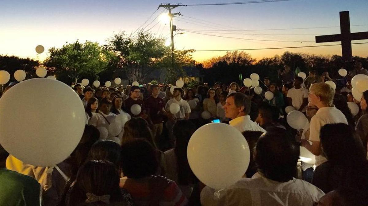 Mourners brought white balloons to the Mass for Carlos Perez in Mansfield on Monday night.