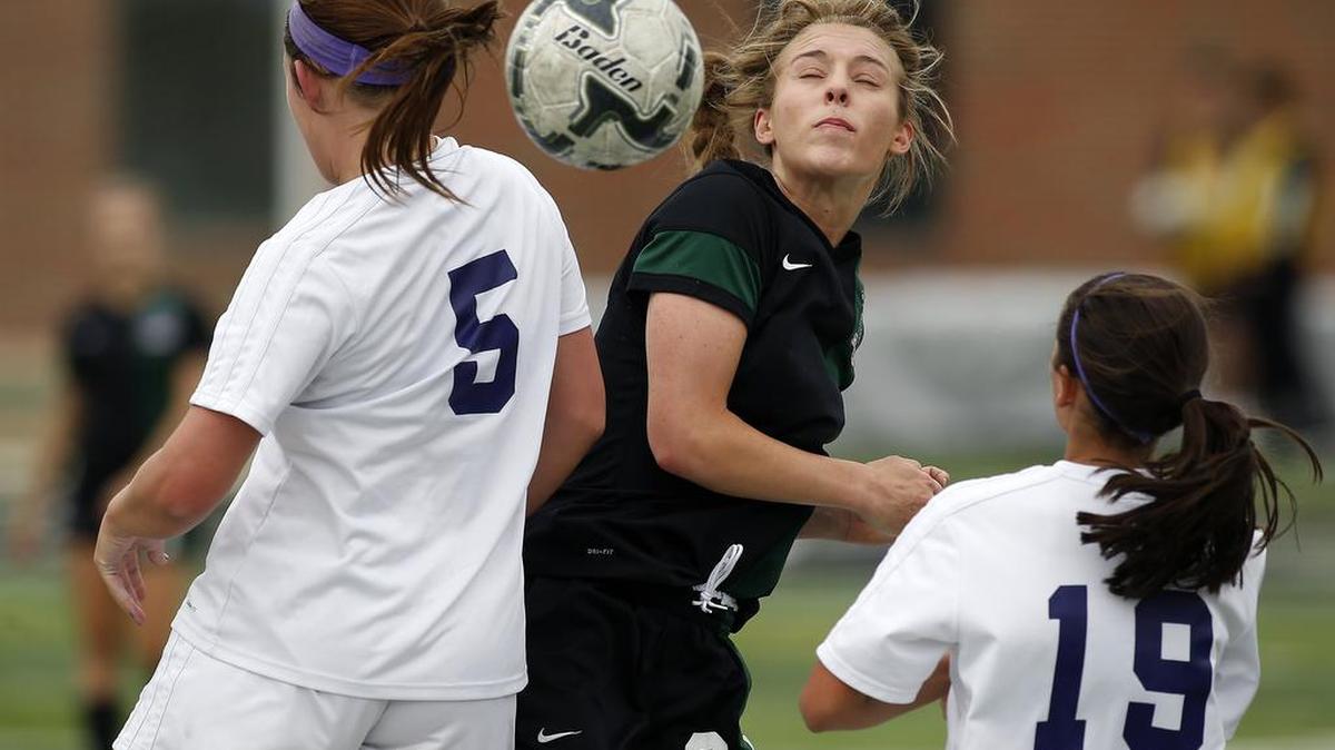 Kennedale Wildcats midfielder Allie Thornton (20) goes for a header against Abilene Wylie’s Peyton Cunningham (5) during the first half .