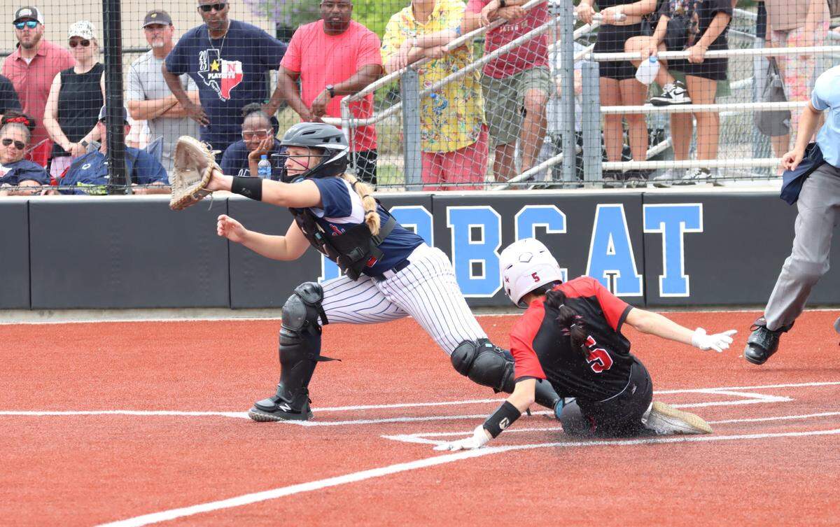 Colleyville Heritage’s Leah Perales slides home with the winning run ahead of the throw to Justin Northwest catcher Taylor Gouge in Game 3 of their Class 5A Region I Final series on Saturday, May 27, 2023 at Byron Nelson High School in Trophy Club, Texas.