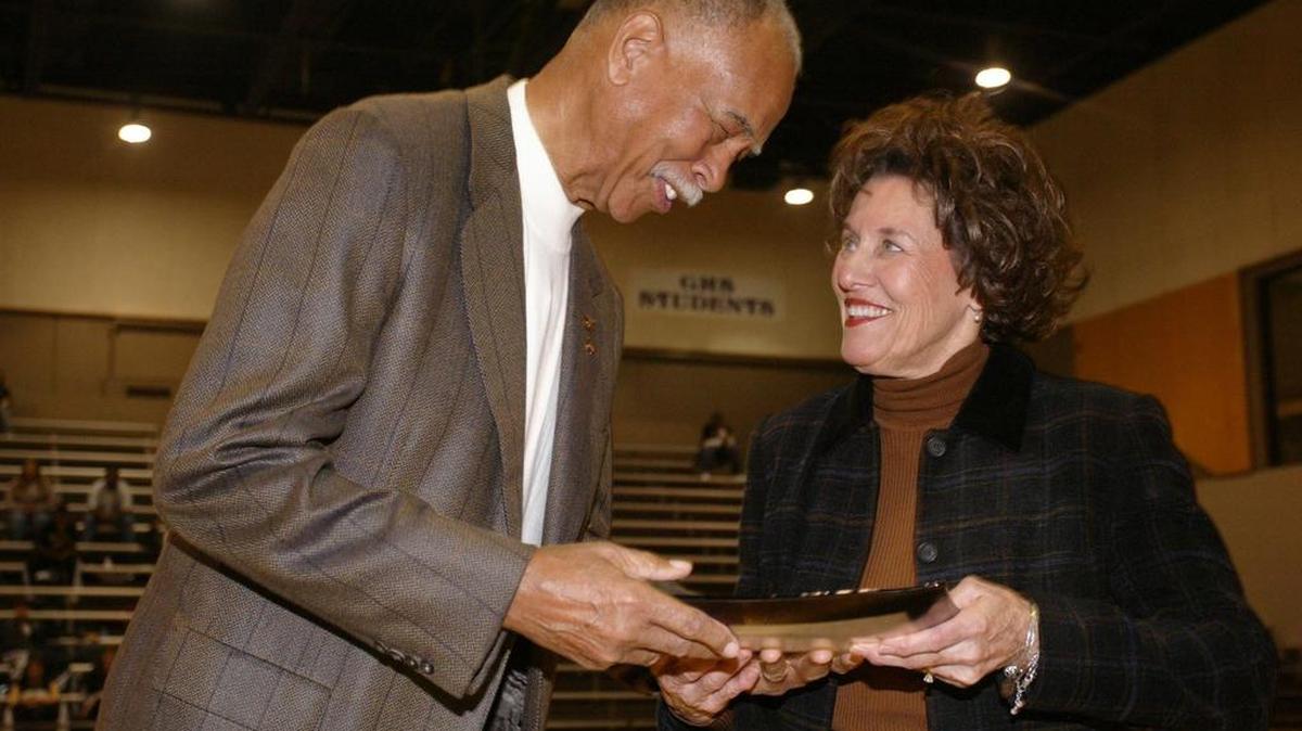 In 2005, retired Dunbar coach Robert Hughes (the boys all-time winningest coach) presents Granbury girls coach Leta Andrews, the new all time winningest girls basketball coach in the country, with a platter honoring her achievement, at Granbury High School gym Saturday December 10, 2005.
