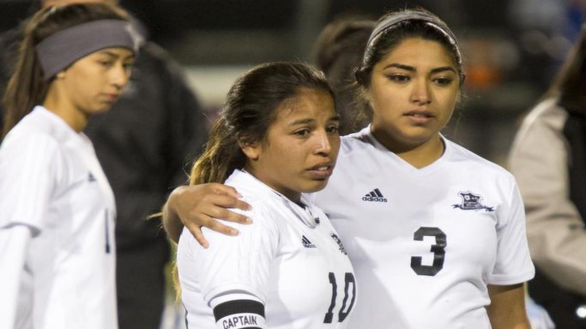 South Hills' Esmie Gonzales (10) is consoled by Maria Morantes (3) after South Hills' 5-1 bi-district playoff loss to Burleson Centennial on March 24, 2016, at North Crowley High School.