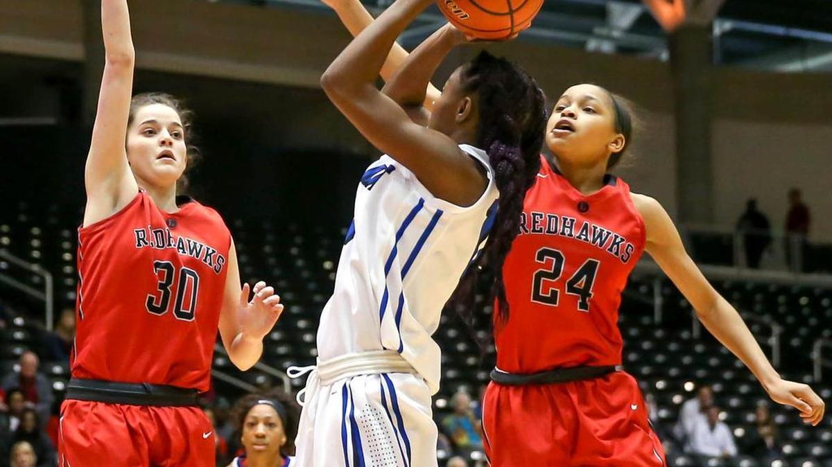 Summit forward Omia Bell tries to get a shot off over Frisco Liberty forward Katelyn Burtch (30) and guard Jordan Hamilton (24) during the first quarterat the Curtis Culwell Center in Garland.