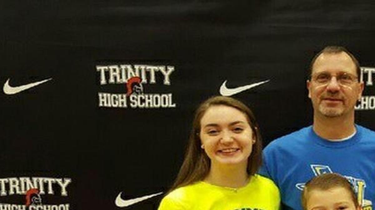 Kenzie Crews, left, is joined by father Kenton, brother Keegan and mother Karina at her signing ceremony.