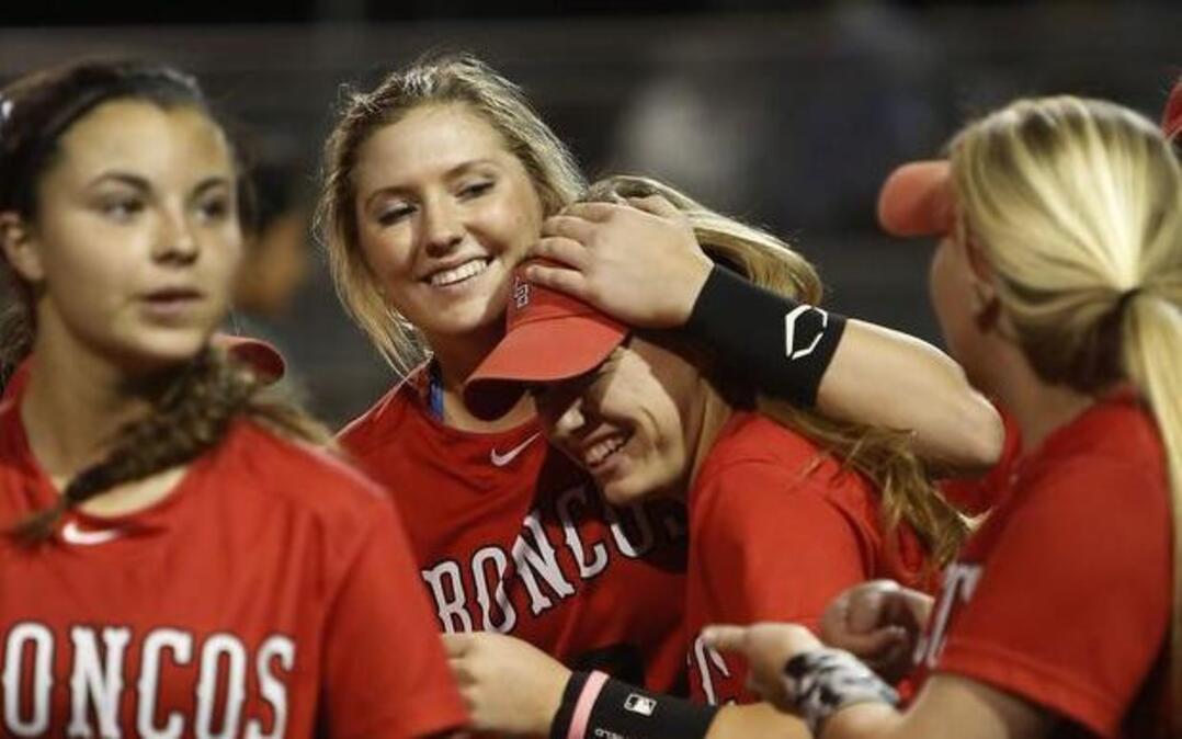 Mansfield Legacy’s Reagan Wright, center, hugs Courtney Taylor after Wright hit a solo homer against Lake Ridge.
