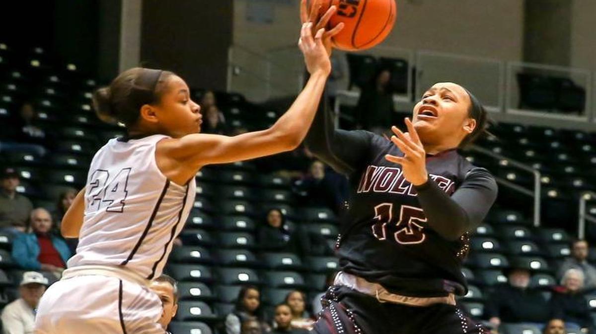 Timberview guard Chennedy Carter (15) tries to get a shot off over Frisco Liberty guard Jordan Hamilton (24) during the first quarter.